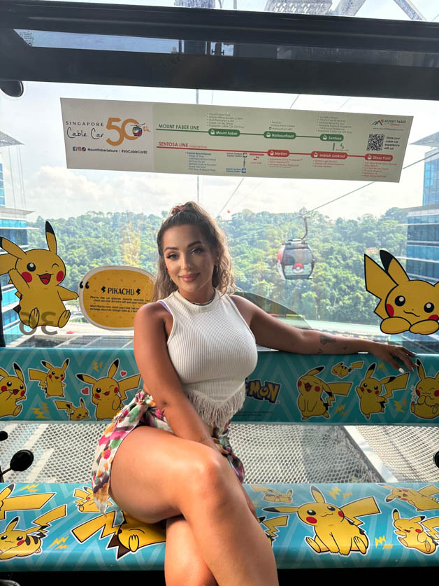 me sitting in a pokemon cable car in singapore high in the air - Itinerary for Singapore 3 days